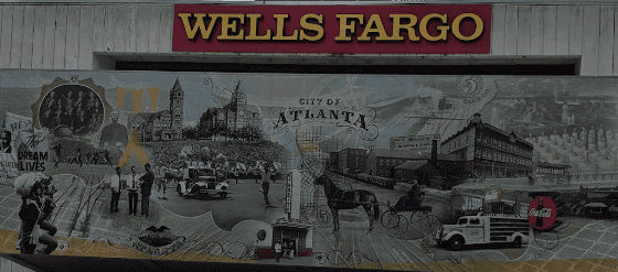 A detailed mural capturing Atlanta’s history displayed on a wall beneath a Wells Fargo sign, showcasing the convenient financing options available to our customers.
